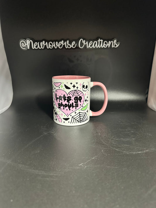 lets go ghouls 11oz mug with a pink handle and inside/ halloween, gothic, pastel goth, spooky vibes, coffin, bones, skulls, grave stone.